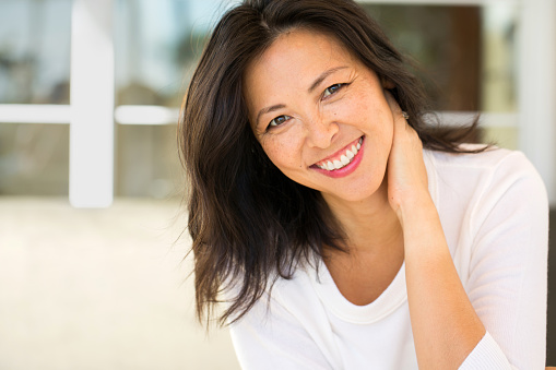 Woman smiling after her panoramic dental x-ray at East Village Dental Centre.